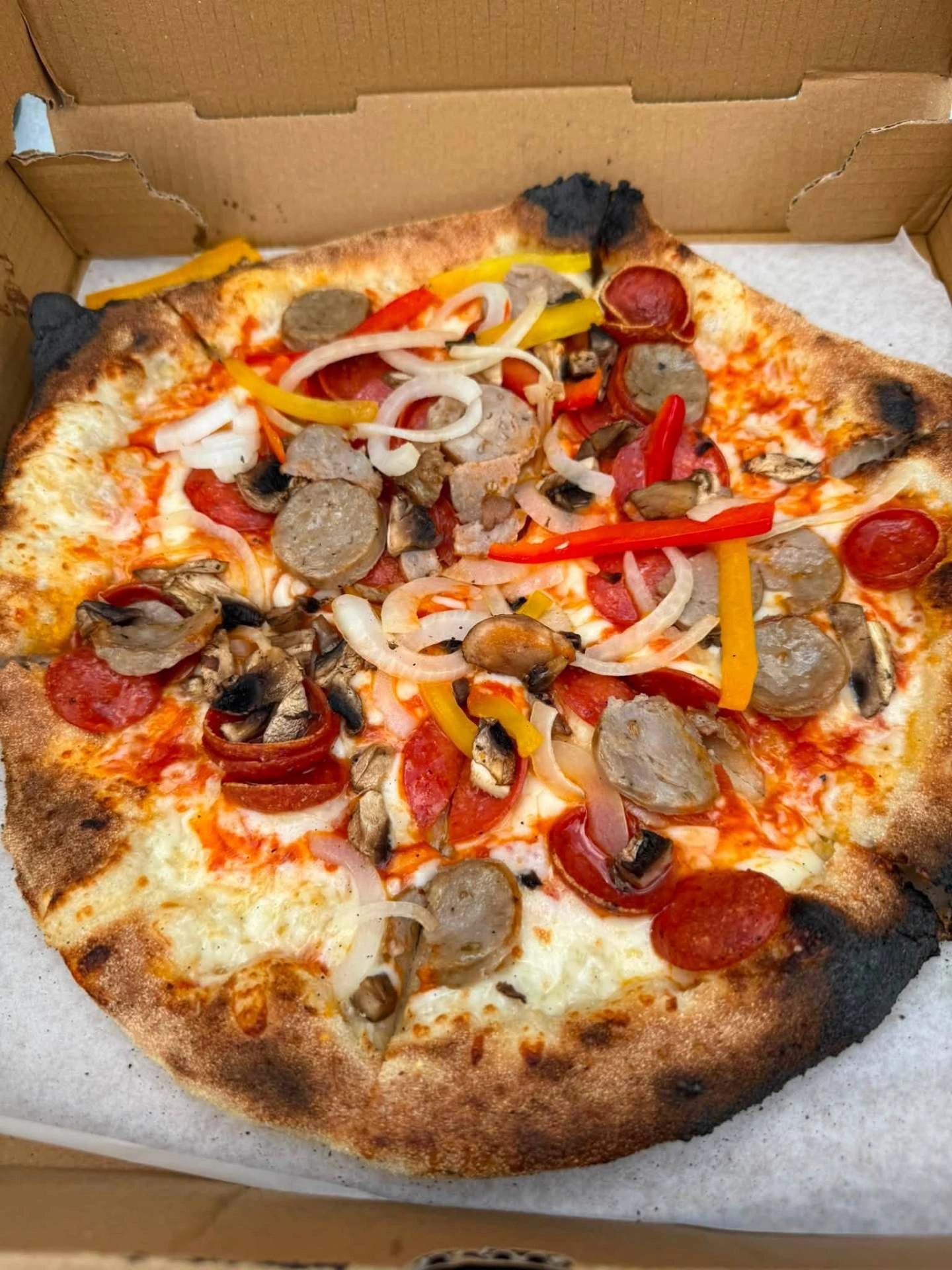 The Works — pepperoni, sausage, mushrooms, peppers and onions on a wood-fired Neapolitan crust